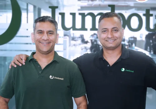 Jumbotail founders celebrating unicorn status after 2025 funding round, showing growth chart and SC Ventures investment visuals.