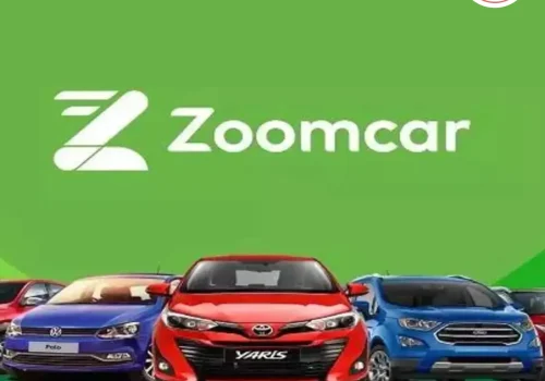 Zoomcar car parked on the street with Zoomcar branding visible — representing Zoomcar’s car rental service.